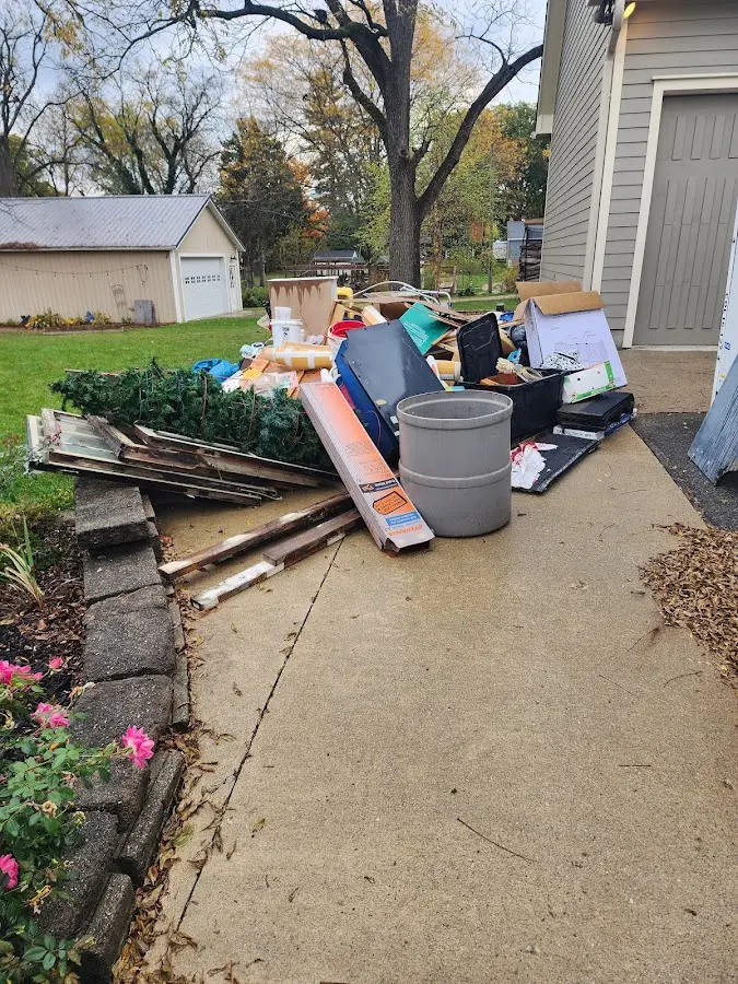 Dumpster being loaded with debris for 30 Yard Dumpster Rental in Uhrichsville